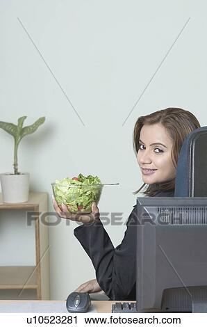 Portrait of a businesswoman holding a bowl of salad View Large Photo Image Stock Image - Portrait of a businesswoman holding a bowl of salad. Fotosearch