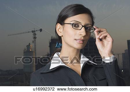 Portrait of a businesswoman holding eyeglasses View Large Photo Image Stock Image - Portrait of a businesswoman holding eyeglasses. Fotosearch