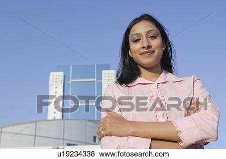 Stock Photo - Portrait of a businesswoman standing with her arms crossed. Fotosearch
