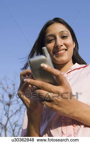 Portrait of a businesswoman using a personal data assistant View Large Photo Image Stock Photo - Portrait of a businesswoman using a personal data assistant. Fotosearch