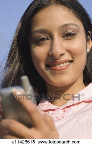 Portrait of a businesswoman using a personal data assistant View Large Photo Image Stock Photography - Portrait of a businesswoman using a personal data assistant. Fotosearch