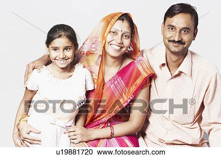 Portrait of a couple sitting with their daughter View Large Photo Image Stock Image - Portrait of a couple sitting with their daughter. Fotosearch