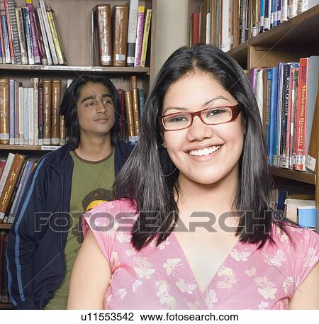 Portrait of a female college student in a library and smiling View Large Photo Image Stock Image - Portrait of a female college student in a library and smiling. Fotosearch