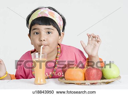 Portrait of a girl drinking juice with a drinking straw View Large Photo Image Stock Image - Portrait of a girl drinking juice with a drinking straw. Fotosearch