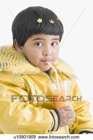 Stock Photo - Portrait of a girl drinking juice with a straw. Fotosearch