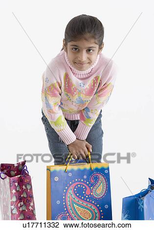 Portrait of a girl holding a shopping bag View Large Photo Image Stock Image - Portrait of a girl holding a shopping bag. Fotosearch