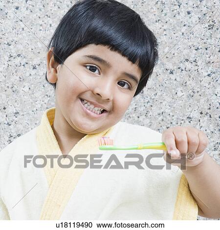 Portrait of a girl holding a toothbrush View Large Photo Image Stock Image - Portrait of a girl holding a toothbrush. Fotosearch