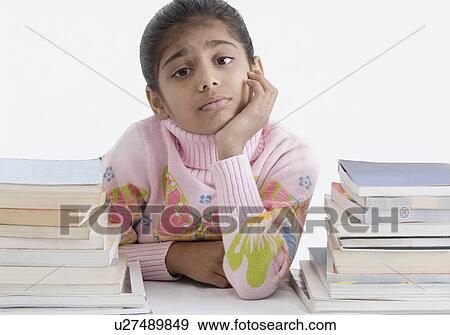 Portrait of a girl leaning on a desk View Large Photo Image Stock Photo - Portrait of a girl leaning on a desk. Fotosearch