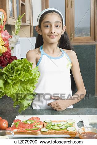 Portrait of a girl making a sandwich View Large Photo Image Stock Image - Portrait of a girl making a sandwich. Fotosearch