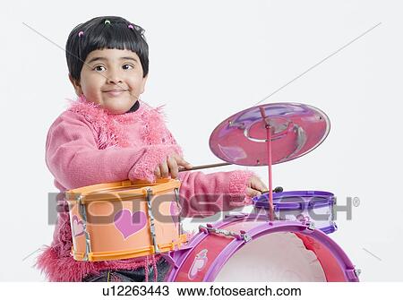 Stock Image - Portrait of a girl playing drums. Fotosearch
