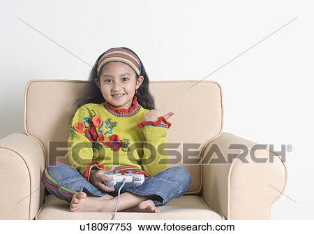 Portrait of a girl playing video game View Large Photo Image Stock Image - Portrait of a girl playing video game. Fotosearch