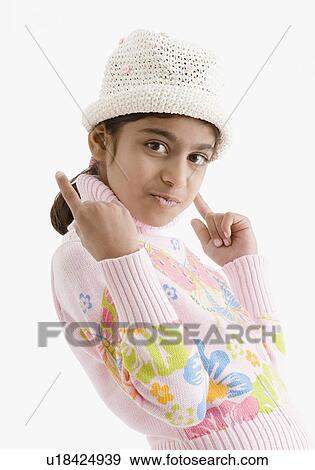 Stock Photo - Portrait of a girl pointing upwards. Fotosearch