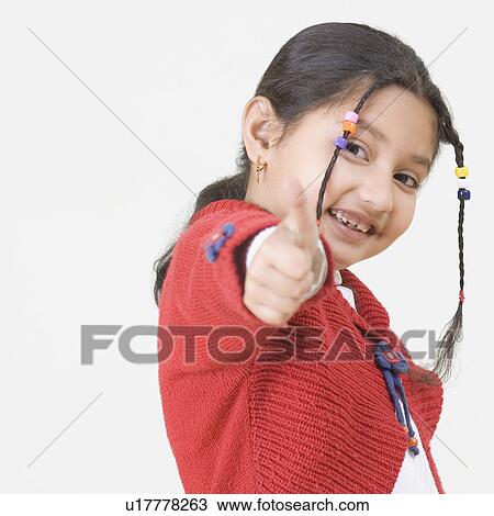 Portrait of a girl showing a thumb up sign View Large Photo Image Stock Image - Portrait of a girl showing a thumb up sign. Fotosearch