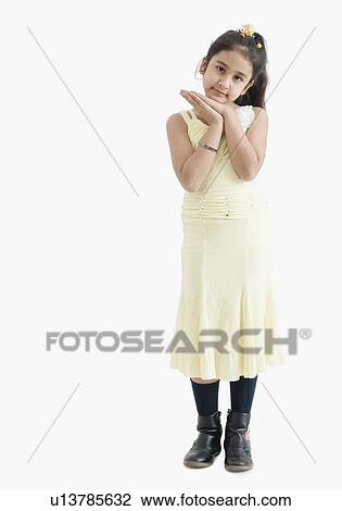 Portrait of a girl standing with her hands clasped View Large Photo Image Stock Image - Portrait of a girl standing with her hands clasped. Fotosearch