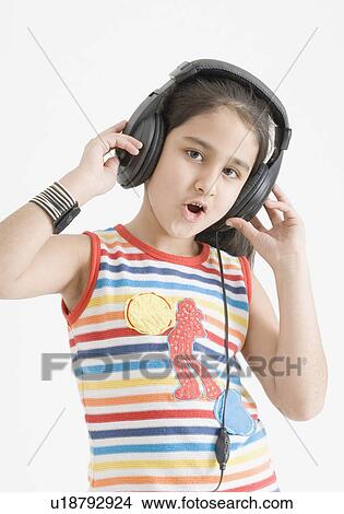 Picture - Portrait of a girl wearing headphones and listening to music. Fotosearch