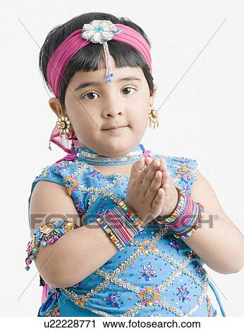 Portrait of a girl wearing traditional clothes and folding her hands View Large Photo Image Stock Image - Portrait of a girl wearing traditional clothes and folding her hands. Fotosearch
