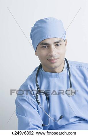 Portrait of a male surgeon with a stethoscope around his neck View Large Photo Image Stock Image - Portrait of a male surgeon with a stethoscope around his neck. Fotosearch