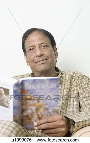 Portrait of a mature man holding the Bhagavad-Gita View Large Photo Image Stock Image - Portrait of a mature man holding the Bhagavad-Gita. Fotosearch