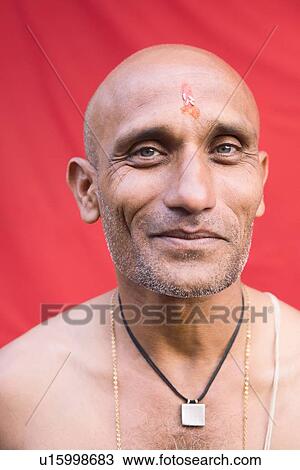Stock Image - Portrait of a mature man smirking. Fotosearch