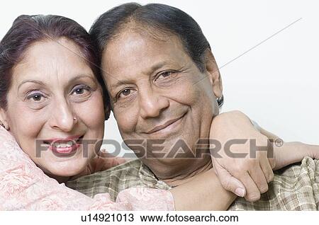 Stock Image - Portrait of a mature woman embracing a mature man and smiling. Fotosearch