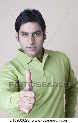 Portrait of a mid adult man showing thumbs up sign View Large Photo Image Stock Photo - Portrait of a mid adult man showing thumbs up sign. Fotosearch