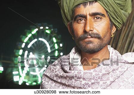 Stock Photo - Portrait of a mid adult man wearing a turban. Fotosearch