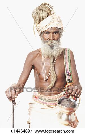 Portrait of a sadhu holding a cane and a kamandal View Large Photo Image Stock Photo - Portrait of a sadhu holding a cane and a kamandal. Fotosearch