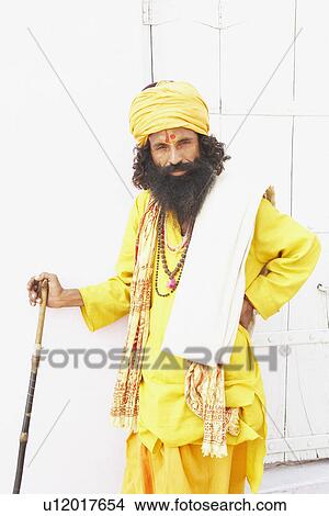 Portrait of a sadhu holding a cane View Large Photo Image Picture - Portrait of a sadhu holding a cane. Fotosearch