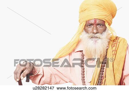 Portrait of a sadhu holding a cane View Large Photo Image Stock Photo - Portrait of a sadhu holding a cane. Fotosearch