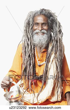 Portrait of a sadhu holding a kamandal and smiling View Large Photo Image Stock Image - Portrait of a sadhu holding a kamandal and smiling. Fotosearch