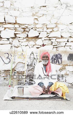Portrait of a sadhu sitting on a mat View Large Photo Image Stock Photo - Portrait of a sadhu sitting on a mat. Fotosearch