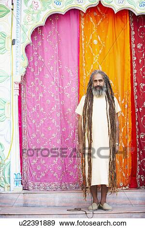 Portrait of a sadhu standing in front of a gate View Large Photo Image Stock Photo - Portrait of a sadhu standing in front of a gate. Fotosearch