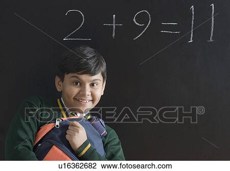 Portrait of a schoolboy holding his schoolbag View Large Photo Image Stock Image - Portrait of a schoolboy holding his schoolbag. Fotosearch
