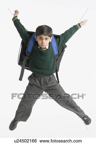 Stock Photograph - Portrait of a schoolboy jumping. Fotosearch