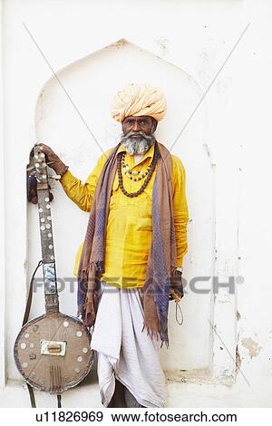 Portrait of a senior man holding a sitar View Large Photo Image Stock Photo - Portrait of a senior man holding a sitar. Fotosearch