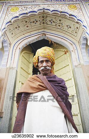 Portrait of a senior man standing at a doorway, Pushkar, Rajasthan, India View Large Photo Image Stock Image - Portrait of a senior man standing at a doorway, Pushkar, Rajasthan, India. Fotosearch