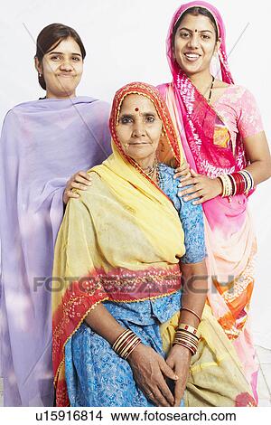 Picture - Portrait of a senior woman sitting and her two daughters standing behind her. Fotosearch