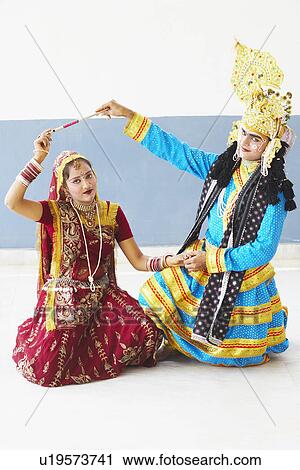 Stock Image - Portrait of a teenage girl and a young man performing Raasleela. Fotosearch