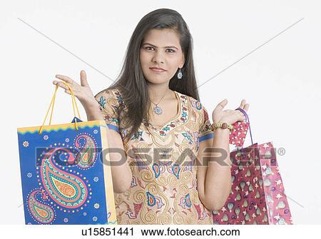 Portrait of a teenage girl holding shopping bags View Large Photo Image Stock Image - Portrait of a teenage girl holding shopping bags. Fotosearch