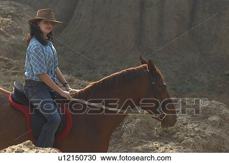 Portrait of a teenage girl riding a horse View Large Photo Image Stock Image - Portrait of a teenage girl riding a horse. Fotosearch