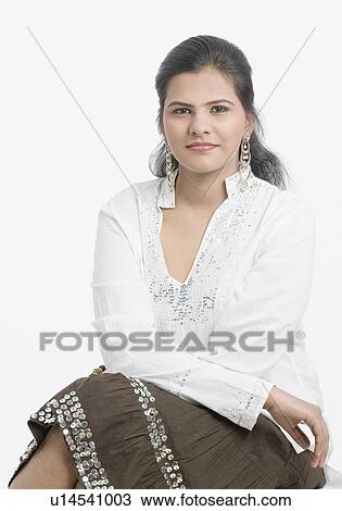 Stock Image - Portrait of a teenage girl sitting with her legs crossed at knee. Fotosearch