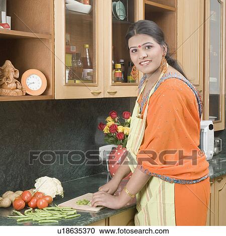 Portrait of a teenage girl working in a kitchen and smiling View Large Photo Image Stock Image - Portrait of a teenage girl working in a kitchen and smiling. Fotosearch