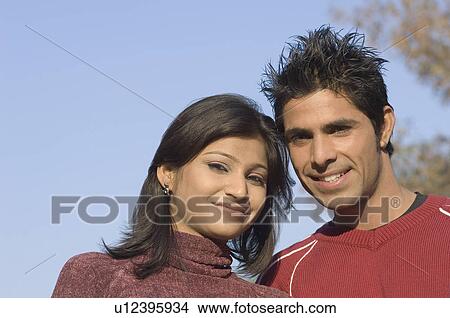 Portrait of a young couple smiling View Large Photo Image Picture - Portrait of a young couple smiling. Fotosearch