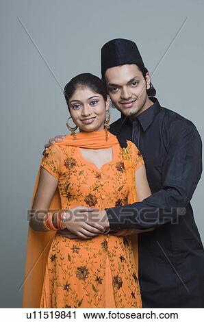 Stock Image - Portrait of a young couple smiling. Fotosearch