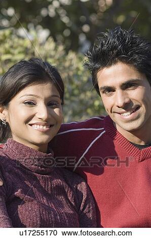 Stock Image - Portrait of a young couple smiling. Fotosearch