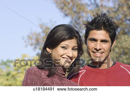 Portrait of a young couple smiling View Large Photo Image Stock Image - Portrait of a young couple smiling. Fotosearch