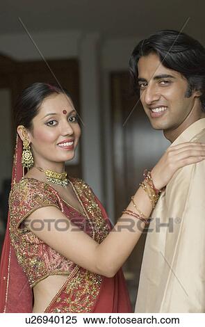 Stock Photography - Portrait of a young couple smiling. Fotosearch