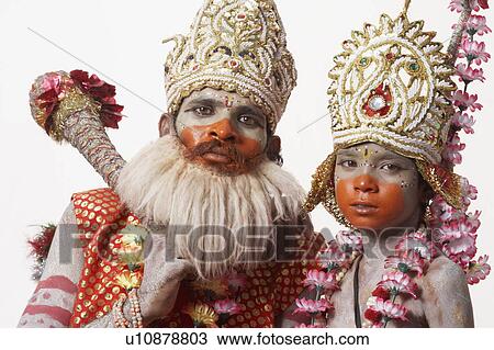 Stock Image - Portrait of a young man and a boy in a traditional clothing. Fotosearch