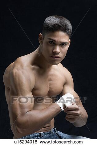 Portrait of a young man bandaging his hand View Large Photo Image Stock Photo - Portrait of a young man bandaging his hand. Fotosearch