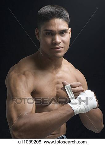 Portrait of a young man bandaging his hand View Large Photo Image Stock Photography - Portrait of a young man bandaging his hand. Fotosearch